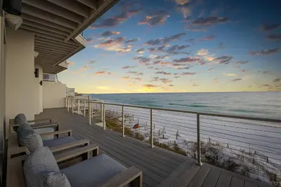 a balcony with a view of the ocean at sunset at Sea Grove - Beachfront, Ocean Views & Balcony in Santa Rosa Beach