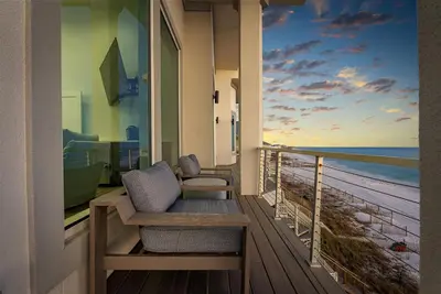 a room with a balcony with a view of the beach at Sea Grove - Beachfront, Ocean Views & Balcony in Santa Rosa Beach