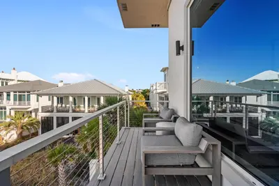 a balcony with chairs on a house at Sea Grove - Beachfront, Ocean Views & Balcony in Santa Rosa Beach