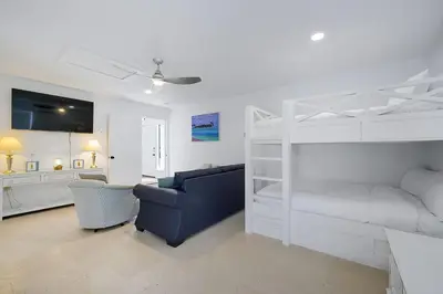 a living room with a couch and a bunk bed at Inlet Getaway - Luxury Vacation Rental Near the Beach with Private Pool Area & Gulf Views in Seacrest