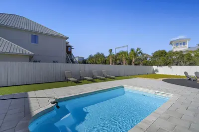 a swimming pool in the backyard of a house at Inlet Getaway - Luxury Vacation Rental Near the Beach with Private Pool Area & Gulf Views in Seacrest