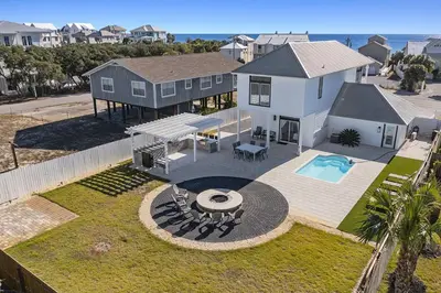 an aerial view of a house with a swimming pool at Inlet Getaway - Luxury Vacation Rental Near the Beach with Private Pool Area & Gulf Views in Seacrest