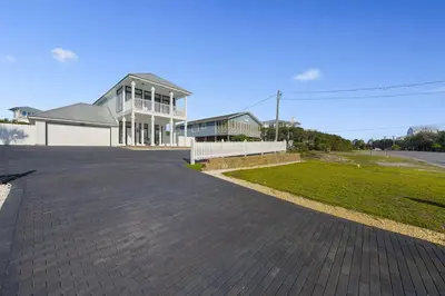 a large parking lot in front of a house at Inlet Getaway - Luxury Vacation Rental Near the Beach with Private Pool Area & Gulf Views in Seacrest