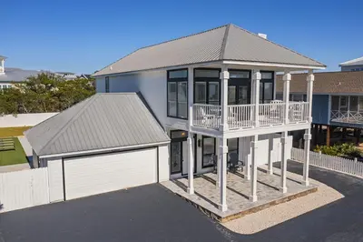 a large house with a balcony and a garage at Inlet Getaway - Luxury Vacation Rental Near the Beach with Private Pool Area & Gulf Views in Seacrest