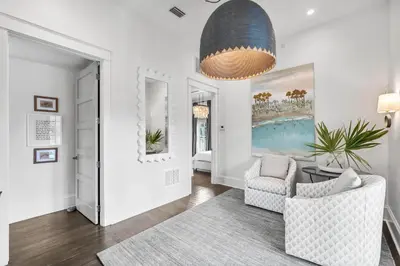 a living room with a couch and a chair at YOLO Cottage in Rosemary Beach