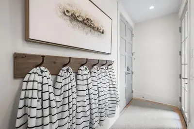 a walk in closet with white walls and a picture on the wall at YOLO Cottage & Carriage in Rosemary Beach