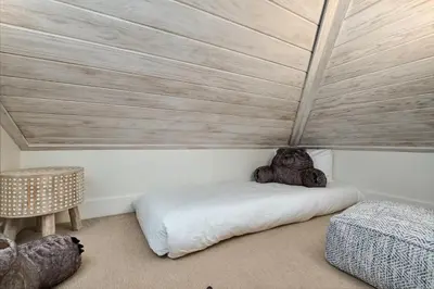 a bedroom with a bed and a wooden ceiling at YOLO Carriage in Rosemary Beach