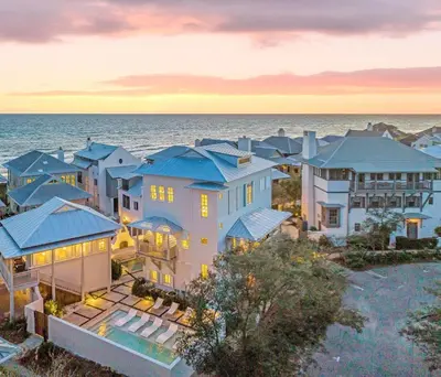 an aerial view of a house with the ocean in the background at YOLO Carriage in Rosemary Beach