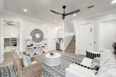 a living room with a couch and a table at Restoration Point in Santa Rosa Beach
