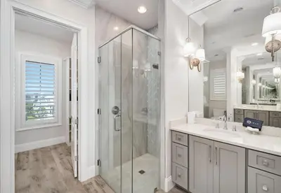 a white bathroom with a shower and a sink at Restoration Point in Santa Rosa Beach