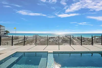 a swimming pool with a view of the ocean at Restoration Point in Santa Rosa Beach