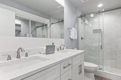 a white bathroom with a sink and a shower at 30A Pet Friendly Beach House - Scissortrail at Treetops in Seacrest