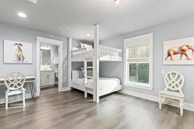 a bedroom with a bunk bed and two chairs at 30A Pet Friendly Beach House - Scissortrail at Treetops in Seacrest