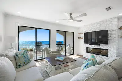 a living room with a fireplace and a tv at Dune Villas 2A - Gulf Front Vacation Condominium with Shared Pool in Santa Rosa Beach