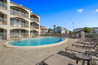 a swimming pool in front of a apartment building at Dune Villas 2A - Gulf Front Vacation Condominium with Shared Pool in Santa Rosa Beach