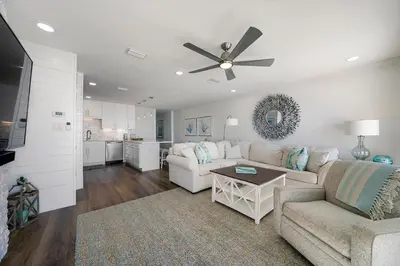 a living room with a white couch and a ceiling fan at Dune Villas 2A - Gulf Front Vacation Condominium with Shared Pool in Santa Rosa Beach
