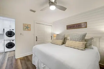 a bedroom with a white bed with a ceiling fan at Dune Villas 2A - Gulf Front Vacation Condominium with Shared Pool in Santa Rosa Beach
