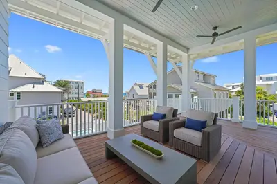 a living room with a couch and chairs on a porch at Pompano Paradise - 30A Vacation House with Ocean Views, Private Pool & Golf Cart in Rosemary Beach