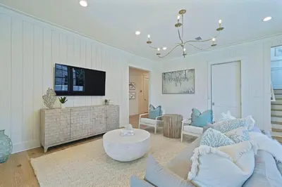a living room with a couch and a tv at Pompano Paradise - 30A Vacation House with Ocean Views, Private Pool & Golf Cart in Rosemary Beach