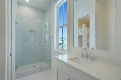 a white bathroom with a sink and a shower at Pompano Paradise - 30A Vacation House with Ocean Views, Private Pool & Golf Cart in Rosemary Beach