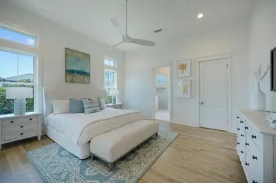 a white bedroom with a bed and a window at Pompano Paradise - 30A Vacation House with Ocean Views, Private Pool & Golf Cart in Rosemary Beach