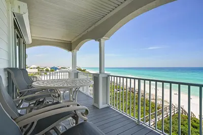 a porch with chairs and a table and the ocean at Seaview 1 Unit 300 - Gulf Front Condo on 30A & Ocean Views in Santa Rosa Beach
