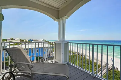 a porch with a chair and a view of the beach at Seaview 1 Unit 300 - Gulf Front Condo on 30A & Ocean Views in Santa Rosa Beach