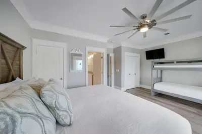 a white bedroom with a bed and a ceiling fan at Southern Charm - Luxury Vacation Rental Near the Beach with Community Pool & Amenities in Seacrest