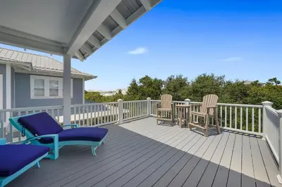 a deck with chairs and a table on a house at Southern Charm - Luxury Vacation Rental Near the Beach with Community Pool & Amenities in Seacrest