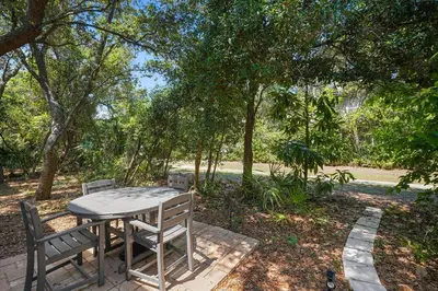 a picnic table and two chairs sitting on a patio at Southern Charm - Luxury Vacation Rental Near the Beach with Community Pool & Amenities in Seacrest