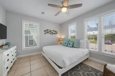 a bedroom with a bed and a ceiling fan at The Sassy Seagull - 30A Beach House with Ocean Views in Seacrest