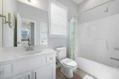 a white bathroom with a sink and a toilet at The Sassy Seagull - 30A Beach House with Ocean Views in Seacrest