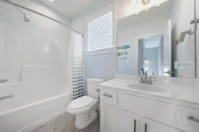 a white bathroom with a sink and a toilet at The Sassy Seagull - 30A Beach House with Ocean Views in Seacrest