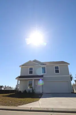 a white house with the sun in the sky at Cozy 4BR Panama City Retreat! Games & Beach Gear! in Panama City