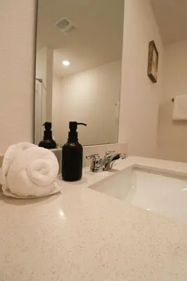 a bathroom with a sink with a towel and a mirror at Cozy 4BR Panama City Retreat! Games & Beach Gear! in Panama City