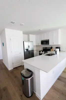 a kitchen with a white counter and a refrigerator at Cozy 4BR Panama City Retreat! Games & Beach Gear! in Panama City