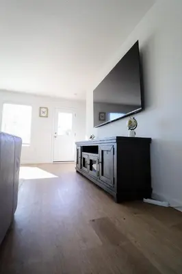 a living room with a flat screen tv on a wall at Cozy 4BR Panama City Retreat! Games & Beach Gear! in Panama City