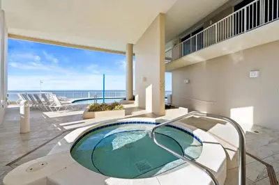 a pool in a house with a view of the ocean at Palazzo Beach Resort by Panhandle Getaways in Panama City Beach