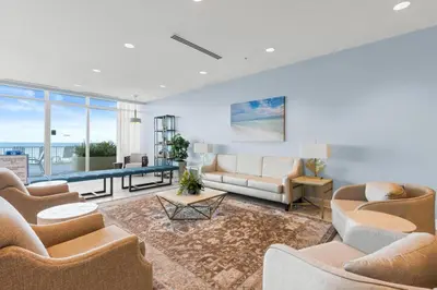 a living room with couches and a table at Palazzo Beach Resort by Panhandle Getaways in Panama City Beach