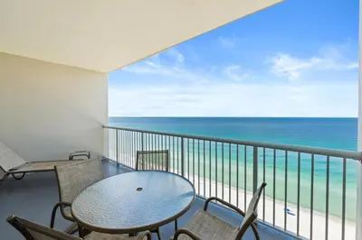 a balcony with a table and chairs and the ocean at Palazzo Beach Resort by Panhandle Getaways in Panama City Beach