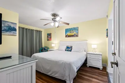 a bedroom with a bed and a ceiling fan at Summit 1417 Beach Resort - Amazing Balcony Views in Panama City Beach