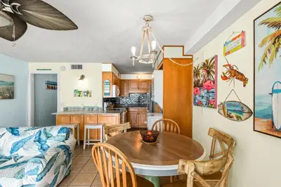 a living room with a table and a couch at Summit 1417 Beach Resort - Amazing Balcony Views in Panama City Beach
