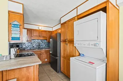 a kitchen with a white refrigerator and a dishwasher at Summit 1417 Beach Resort - Amazing Balcony Views in Panama City Beach