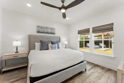 a bedroom with a bed and a ceiling fan at Beach House with Private Pool - Sunny Sands by Panhandle Getaways in Panama City