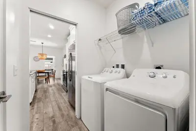a white laundry room with a washer and dryer at Beach House with Private Pool - Sunny Sands by Panhandle Getaways in Panama City