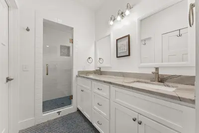 a white bathroom with a double sink and a shower at Beach House with Private Pool - Sunny Sands by Panhandle Getaways in Panama City