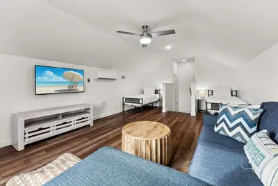 a living room with a couch and a table at Beach House with Private Pool - Sunny Sands by Panhandle Getaways in Panama City