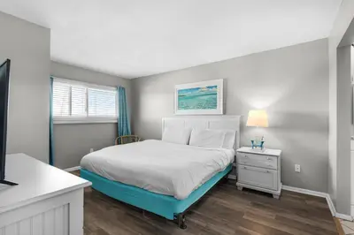 a small bedroom with a bed and a desk at Summit 807 Beach Resort - Amazing Balcony Views in Panama City Beach