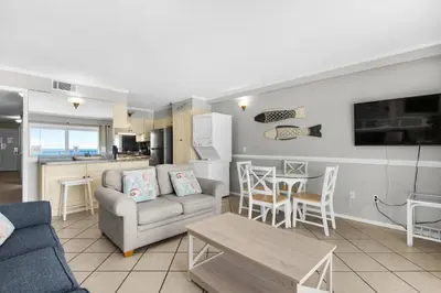 a living room with a couch and a table at Summit 807 Beach Resort - Amazing Balcony Views in Panama City Beach
