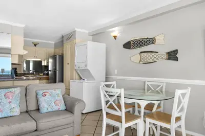 a living room with a couch and a table at Summit 807 Beach Resort - Amazing Balcony Views in Panama City Beach